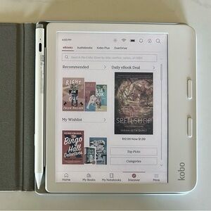Kobo Libra Color with beige magnetic case, white stylus, and charging materials